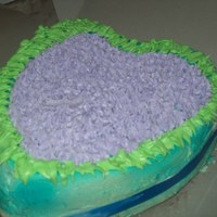 Flower Heart Cake Dark Chocolate and cherry, blue ribbon and blue airbrushing, the flowers and leaves a client wanted becuase his wife loves "purple...
