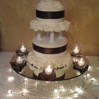 My First Tiered Cake I made this cake for my sister-in-laws bridal shower. All buttercream frosting with brown ribbon around each tier and fudge filling.