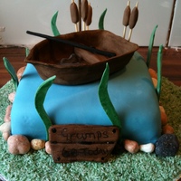 Boat Cake A pond cake with a fondant boat, and accessories made out of fondant also.