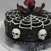 Goth Cake Strawberry cake flavor with fresh Strawberries & Glaze and Strawberry bc. The spider web and Skulls are made with chocolate. The flower...