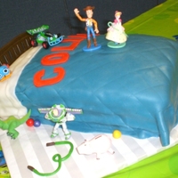 Colin's Toy Story Bed Toy Story bed for my cousin's little boy's 3rd birthday! Covered in a fondant blanket with fondant toy balls and headboard. The...