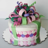 Present Cake The customer asked for polka dots, a big bow, and pastel colors. The inside is chocolate with fudge filling. Very happy with the results!