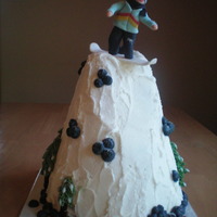Snowboarding 5 layers of cake, carved with a fondant guy on top. Buttercream trees with modeling chocolate trunks around the back of the mountain.