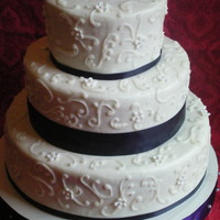 Scroll Cake My very first wedding cake. 100% humidity and satin ribbon aren't freinds!!! Lesson learned. Is there ANYTHING you can do to control...