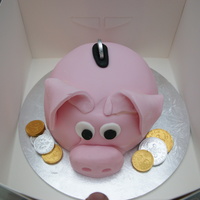 Piggy Bank My first attempt at a piggy bank. Lemon sponge filled with buttercream. Fondant decoration.