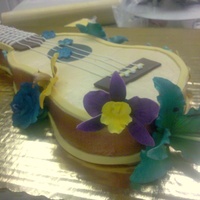 Ukulele Cake This is airbrushed buttercream with gumpaste flowers and fondant details.