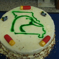 Missouri Ducks Unlimited Decal Bannana Cake with MO DU decal airbrushed on it. Gumpaste shotgun shells and duck decoys.