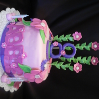 "flower Birthday Cake" This is a one tier cake for a little girl named Abbie. She was turning eight and loved the colors pink, purple, and green. She wanted...