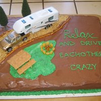 Camping Buttercream frosting. Real truck and 5th wheel. Crushed grahamn cracker for the road. Pretzel sticks for the road liner and fire wood....