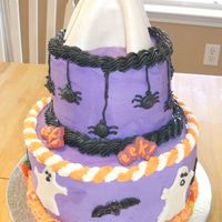 Halloween Cake With Ghosts & Spiders Cake is frosted in buttercream. Ghost around side and on top are fondant. Eek signs are candymelts. Spiders are buttercream. Cake made for...