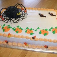 Halloween Cake With Spider Spider is mini ball with a marshmallow for the head. Frosted in Buttercream. Bats are candymelts and candy around the border. Made for...