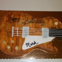 1959 Les Paul Guitar Chocolate cake with buttercream frosting, fondant accents, gold and silver leaving on "knobs".