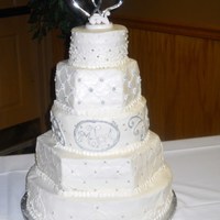 Round And Hexagon Cake 16' round, 14in hex, 12in round, 9in hex, and 6 in round. Buttercream with fondant accents and silver dragees. Mixed different aspects...