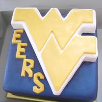 West Virginia University Marshmallow fondant covered cake with 3-D WVU logo sculpted from rice crispy cereal treats covered in white chocolate, then covered in...
