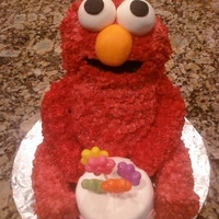 Elmo Holding B-Day Cake Made head, legs, and arms out of RKT. Piped fur with grass tip and added molded fondant for facial features.