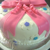 Wilton Course 3 Cake - Present Fondant bow, flowers, etc.8" round cakeMy bow is a little flat, not sure how to get it to stand up, maybe use gum paste in the future...