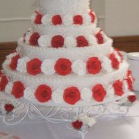 Nellie.jpg Four tier wedding cake in vanilla with pastillage roses in red and white. As soon the bride saw the cake she call me and thanks me for her...