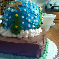 Christmas Snow Globe First round cake I made, the cakes are frosted in buttercream. Santa, his reindeer and christmas trees are all fondant cut out with cookie...