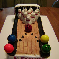 A Striking 10Th Birthday Marble cake with rkt bowling pins and large bubblegum ball bowling balls.