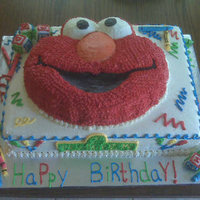 Elmo's World Cake placed wilton pan cake onto sheet cake. Made fondant/gum paste crayons and ABC blocks.