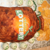 Georgia Lottery Cake Money Bag Money Bag cake covered in MMF, logo made from gumpaste. Coins made form mold that I made from a Silver Kennedy Dollar, lotto balls are cake...