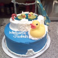 A Rubber Duckie Welcome White cake with chocolate ganache filling, covered in buttercream frosting. The tub is german chocolate, the water blue jello. Gumpaste...