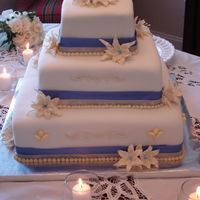 Wedding Lilies - May 2006 Wedding Lilies - Royal Icing Lilies & Leaves with Periwinkle Centers. Cream & periwinkle ribbon accents.