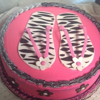 Flip Flop Birthday Cake basic birthday cake recipe with buttercream icing. zebra print flip flops made out of gumpaste. black flowers are fondant. tfl!