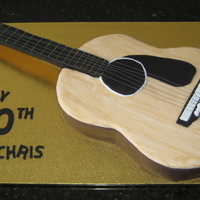 Guitar Cake Butter cake with vanilla buttercream filling. Covered with white and chocolate fondant. Painted with gel colour/vodka. Neck of the guitar...