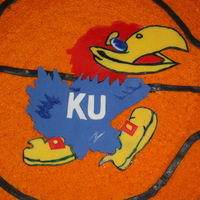 Jayhawk Basketball Cake Fondant Jayhawk, cut out fondont pieces and put together on cake, painted outlines with food coloring.