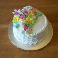 Mother's Day 2010 8" round white almond cake with raspberry filling, iced in almond buttercream, basketweave style. Covered with tons of gumpaste...