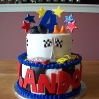 Landon's 4Th Birthday 8 and 6" round chocolate cake iced in buttercream. All decorations fondant except gumpaste racing flags. Die-cast race cars.