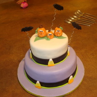 Halloween Birthday Pumpkin toppers made with gumpaste. Cake covered with MMF.Candy corn is also fondant