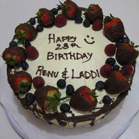 Cousins Birthday Cake This is a vanilla cake with vanilla buttercream with fresh berries. I had dipped the strawberries, which were a lot of fun..........mmmh!...