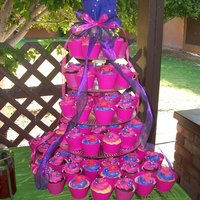 Fussia Cupcake Tower I made the pink wrapers because i couldnt find them. Was a lot of work on this cake but was worth it. :)