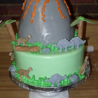 Children's Dinosaur Cake This is a cake my husband and I did for our neighbor's daughter. They wanted a dinosaur themed cake with a volcano. The dinosaurs are...