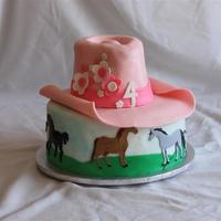 Cowgirl Cow girl cake for a 4 year old. Chocolate and yellow cake w/ fondant decorations. Horses are hand painted.