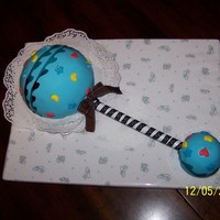 Baby Rattle Used sports ball and mini sports ball pans. Lemon cake with lemon filling covered with fondant and fondant cutouts. Used fruit rollup for...