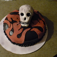 Death Race.....first Time Skull This was a very fun project. The skull was my very first attempt using rice krispies and fondant. The cake is almond vanilla with orange...