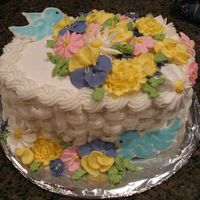 Basketweave Buttercream And Royal Icing Flowers This was my graduation cake from the Wilton Course II cake class. The royal icing flowers were made over the course of the class, along...
