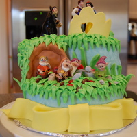Snow White Frosted with BC. Stones are chocolate candies, crown is gumpaste, & cave door is fondant. Snow White figurines were purchased by the...