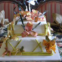 Tropical Orchid Wedding Cake This 2 tier cake was decorated with gumpaste orchids ( colored with petal dust ), leaves and bamboo, which I made from a silicone mold . I...