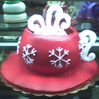 Mug Of Hot Chocolate With Snowflakes A double layer cake with whipped icing and real marshmallows. The handles and steam are made from piped confectionary coating.