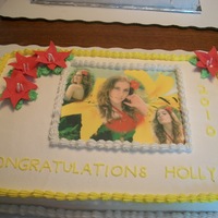 Grad A lilie cake with her grad picture .