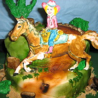 Hanna's Cowboy Horse is painted gum paste, cake is butter cream. White chocolate cactus.