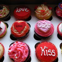 Valentines Cupcakes Assorted cupcakes (choc, vanilla, lemon, red velvet) with vanilla buttercream and fondant accents.Some topped with mini sugar cookies