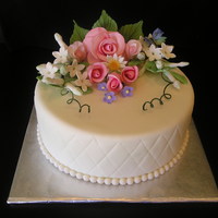Fondant Covered With Hand Quilting And Gumpaste Flowers Here's my second fondant covered cake; it's a dummy though. Just trying to get a handle on MMF. I previously made the rose spray...