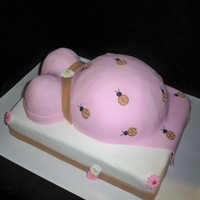 Prego Belly Pink/Brown lady bugs @ clients request.. belly is choco base in vanilla.. all fondant covered.. flowers are sugar bought from my local...