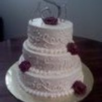 Wedding Cake For 9-11-2010 Lemon cake with raspberry bc filling and ivory bc. Scroll design and bc roses. Thanks for looking!
