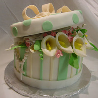 Hat Box Cake Gum paste flowers, tissues, cross and bow; fondant covered rice cereal top. First try at a hatbox... thanks for all the instructions found...